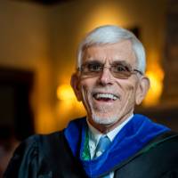 Man smiles after receiving his award